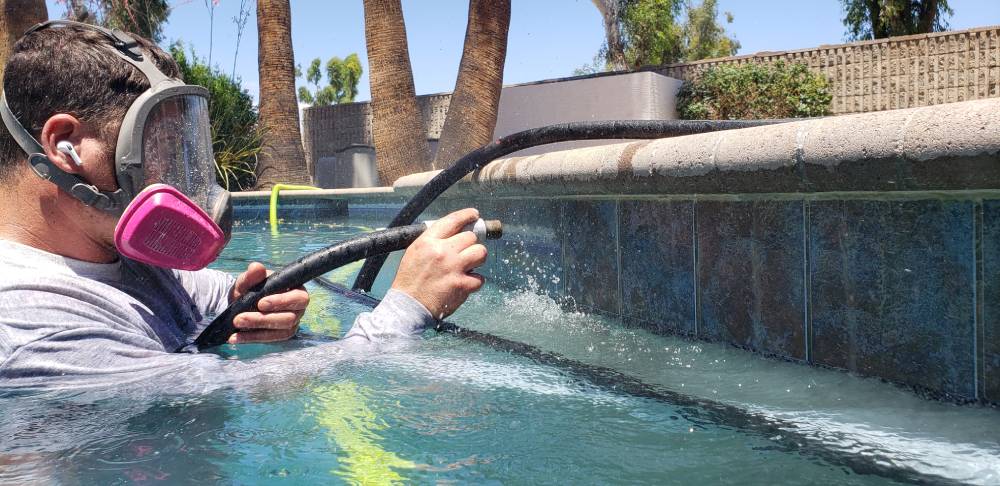 A Man Wearing A Mask Washing Swimming Pool